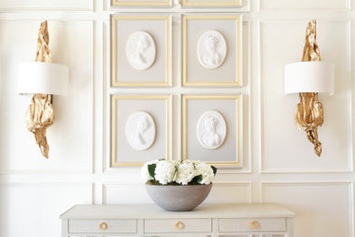 Entry hall - transitional light wood floor, beige floor and wall paneling entry hall idea in New Orleans with white walls
