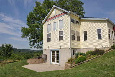 Inspiration for a large cottage yellow three-story wood gable roof remodel in Cincinnati