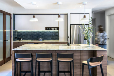 This is an example of a mid-sized contemporary kitchen in Melbourne with an undermount sink, medium wood cabinets, granite benchtops, blue splashback, porcelain splashback, stainless steel appliances, porcelain floors and with island.