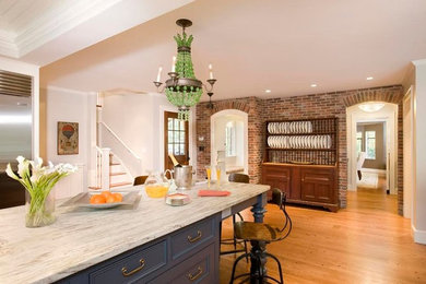 Eat-in kitchen - large traditional u-shaped medium tone wood floor eat-in kitchen idea in Boston with recessed-panel cabinets, blue cabinets, marble countertops, gray backsplash, ceramic backsplash, stainless steel appliances and an island