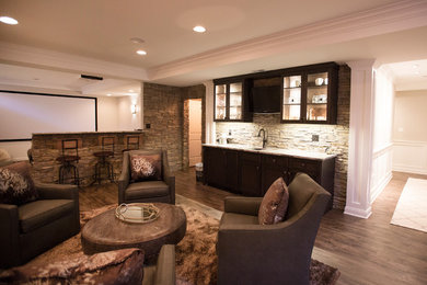 This is an example of a large transitional open concept family room in Chicago with vinyl floors, a game room, beige walls, no fireplace, a built-in media wall and brown floor.