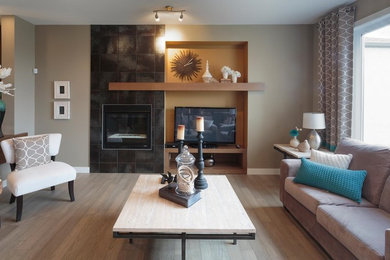 Inspiration for a mid-sized modern light wood floor and beige floor living room remodel in San Diego with beige walls, a standard fireplace and a tile fireplace