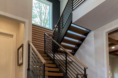 Large trendy wooden straight mixed material railing and wall paneling staircase photo in DC Metro