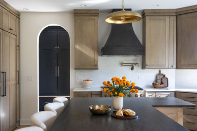 Large transitional medium tone wood floor eat-in kitchen photo in Chicago with shaker cabinets, brown cabinets, white backsplash, quartz backsplash, paneled appliances and an island