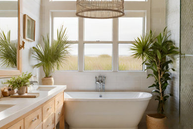 Mid-sized beach style master green tile and mosaic tile mosaic tile floor, multicolored floor, double-sink and shiplap wall bathroom photo in Charleston with shaker cabinets, light wood cabinets, white walls, an undermount sink, quartzite countertops, a hinged shower door, white countertops and a freestanding vanity