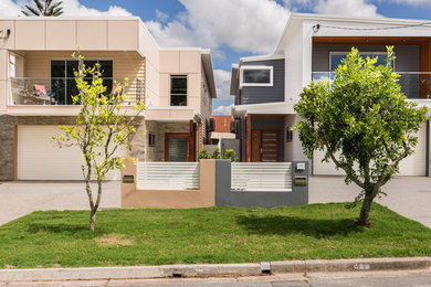 Design ideas for an expansive industrial two-storey grey exterior in Brisbane with concrete fiberboard siding.