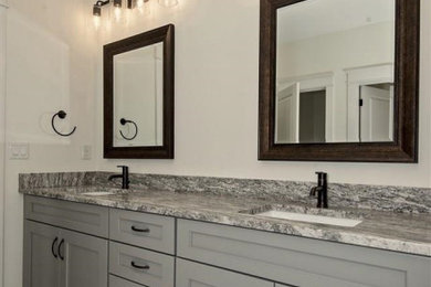 Bathroom - large traditional master gray tile and porcelain tile porcelain tile and white floor bathroom idea in DC Metro with shaker cabinets, gray cabinets, beige walls, an undermount sink, granite countertops and gray countertops