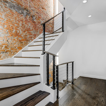 Dramatic Staircase with Exposed Brick