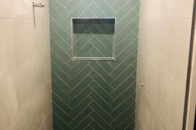 Design ideas for a modern 3/4 bathroom with green tile, ceramic tile, grey walls, porcelain floors and grey floor.