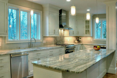 Kitchen - large transitional u-shaped dark wood floor and brown floor kitchen idea in Boston with an undermount sink, recessed-panel cabinets, white cabinets, quartzite countertops, beige backsplash, subway tile backsplash, stainless steel appliances, an island and multicolored countertops