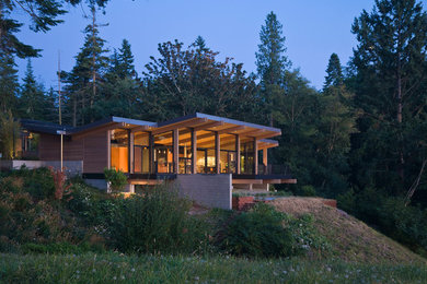 Large 1950s multicolored one-story wood house exterior photo in Seattle with a shed roof