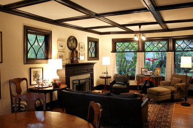 Mid-sized arts and crafts medium tone wood floor living room photo in Seattle with beige walls, a standard fireplace and a tile fireplace