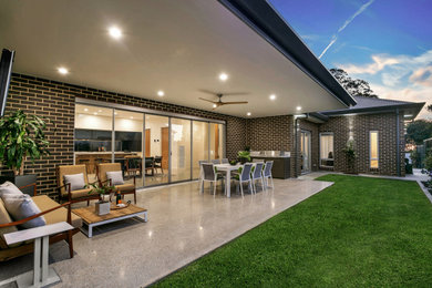 Large contemporary side yard verandah in Adelaide with an outdoor kitchen and a roof extension.