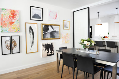 Inspiration for a transitional light wood floor and beige floor dining room remodel in Vancouver with white walls