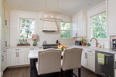 Example of a mid-sized transitional u-shaped dark wood floor eat-in kitchen design in Atlanta with a double-bowl sink, shaker cabinets, beige cabinets, quartzite countertops, white backsplash, subway tile backsplash, stainless steel appliances and an island