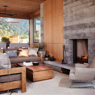 Immagine di un piccolo soggiorno stile marino aperto con camino classico e cornice del camino in cemento