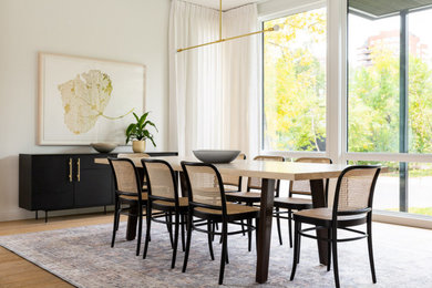 Inspiration for a large contemporary open plan dining in Calgary with white walls, light hardwood floors and beige floor.