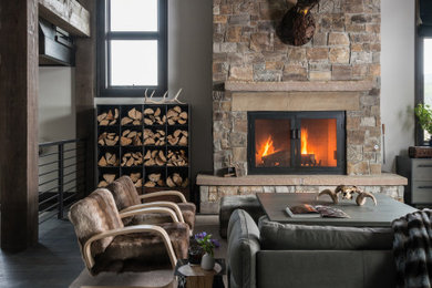 Large mountain style open concept wood ceiling living room photo in Other with a stone fireplace
