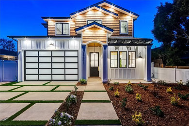 Large minimalist multicolored two-story wood and shingle exterior home photo in Los Angeles with a shingle roof and a gray roof