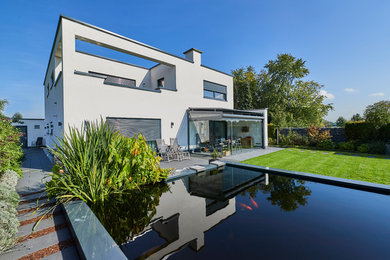 Mittelgroßer, Oberirdischer Moderner Pool neben dem Haus in rechteckiger Form mit Betonplatten in Essen