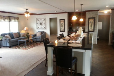 This is an example of a mid-sized l-shaped eat-in kitchen in Atlanta with raised-panel cabinets, dark wood cabinets, granite benchtops, with island and medium hardwood floors.