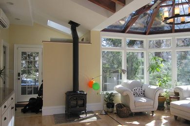 Inspiration for a large traditional sunroom in Boston with a wood stove.