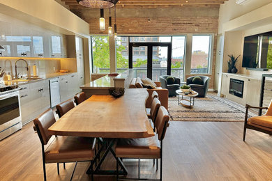 Example of a mid-sized urban exposed beam and brick wall kitchen/dining room combo design in Salt Lake City with a standard fireplace