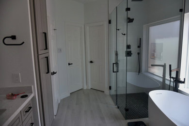 Transitional master white tile double-sink bathroom photo in Houston with gray cabinets, white walls, a hinged shower door, multicolored countertops and a built-in vanity