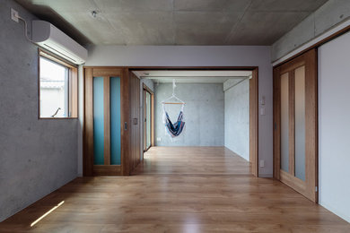 Inspiration for a mid-sized modern open concept living room in Tokyo with plywood floors, multi-coloured walls and brown floor.