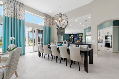 Design ideas for a large beach style kitchen/dining combo in Miami with beige walls, marble floors, a ribbon fireplace, a stone fireplace surround and beige floor.
