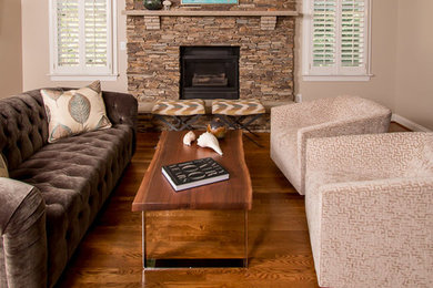 Example of a mid-sized trendy medium tone wood floor family room design in Charlotte with beige walls, a standard fireplace, a stone fireplace and a wall-mounted tv