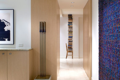Inspiration for a contemporary beige floor and wall paneling hallway remodel in Chicago with white walls