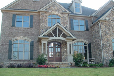 Inspiration for a timeless two-story stone exterior home remodel in Atlanta