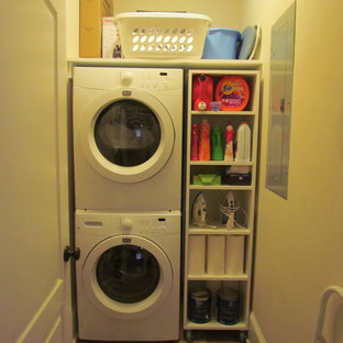 Contemporary utility room in Atlanta with a stacked washer and dryer.