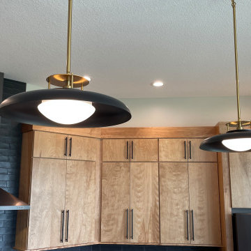 Angled Kitchen Design with Slab Style Cabinets in Pecan Stain