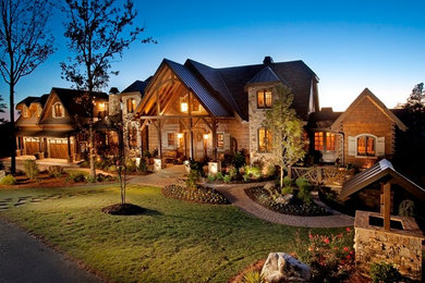 Inspiration for an expansive traditional three-storey brown house exterior in Atlanta with wood siding.