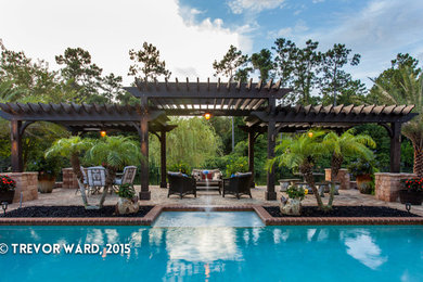 Example of a trendy backyard brick patio design in Jacksonville with a pergola
