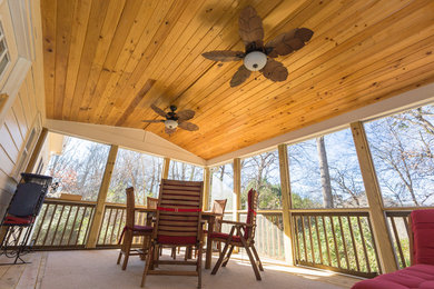 Inspiration for an arts and crafts backyard screened-in verandah in Atlanta with decking and a roof extension.