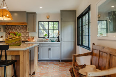 Tuscan terra-cotta tile and brown floor kitchen photo in Los Angeles with shaker cabinets, gray cabinets, quartzite countertops, stainless steel appliances, an island and beige countertops