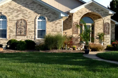 Mid-sized arts and crafts beige one-story mixed siding exterior home photo in St Louis