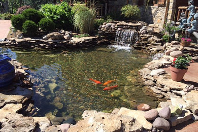 Inspiration for a large asian full sun backyard stone landscaping in Other.