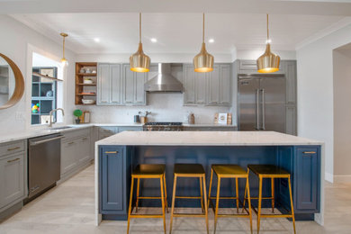 Inspiration for a large contemporary l-shaped eat-in kitchen in Phoenix with an undermount sink, shaker cabinets, grey cabinets, marble benchtops, white splashback, ceramic splashback, stainless steel appliances, ceramic floors, with island, beige floor and white benchtop.
