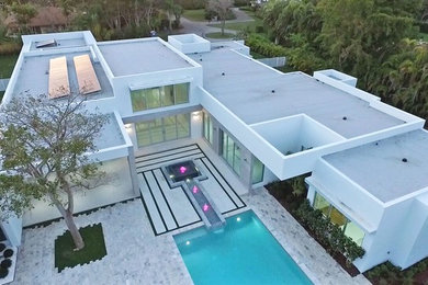 Huge modern white one-story concrete exterior home idea in Orange County