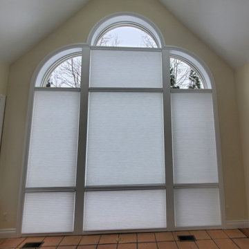Wall of windows with quarter rounds and arch on top