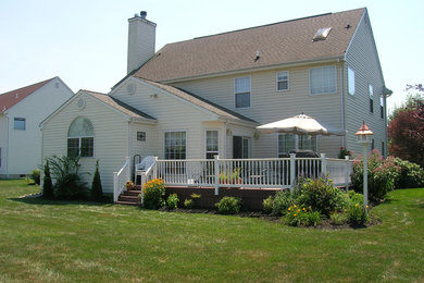 Large elegant yellow two-story wood gable roof photo in Philadelphia