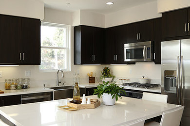 Open concept kitchen - contemporary l-shaped open concept kitchen idea in Los Angeles with a farmhouse sink and an island