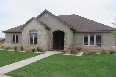 Mid-sized traditional gray one-story stucco exterior home idea in Austin with a hip roof