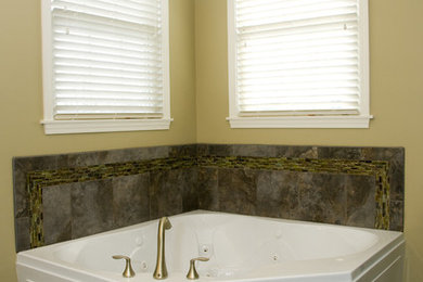 Inspiration for a mid-sized transitional master gray tile porcelain tile and gray floor corner bathtub remodel in Other with an undermount sink, granite countertops and a hinged shower door