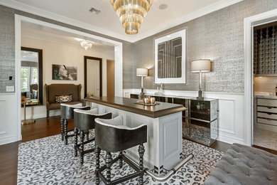 Example of a large minimalist galley dark wood floor and brown floor seated home bar design in San Diego with gray cabinets, marble countertops and brown countertops