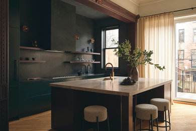 Inspiration for a mid-sized contemporary galley medium tone wood floor and brown floor kitchen remodel in New York with flat-panel cabinets, green cabinets, quartzite countertops, black backsplash, an island, an undermount sink and black countertops
